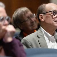 Audience members listening to speaker